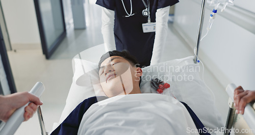 Image of Asian man, patient and push bed in hospital for surgery, emergency or medical problem in corridor. Medicine, professional or person with stretcher for wellness, service and risk in clinic or job