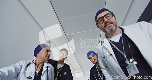 Image of Pov, doctors and team push patient for emergency, surgery or operation in hospital. Low angle, surgeon group and rush to ICU, talking and help for medical treatment, healthcare support and wellness