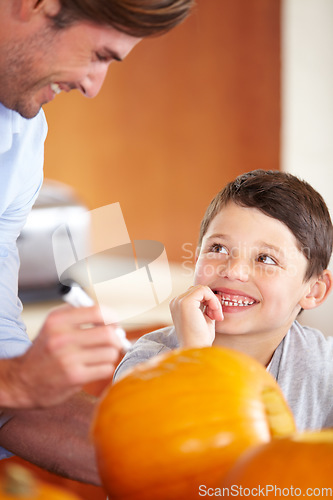 Image of Halloween, pumpkin and father with kid in the kitchen for holiday celebration at home. Creative, smile and happy dad with boy child bonding and carving vegetable for decoration or tradition at house.