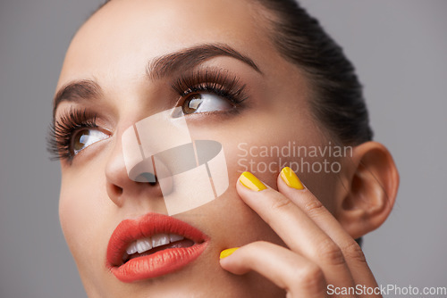 Image of Face, makeup and thinking with manicure of woman in studio isolated on gray background for cosmetology. Beauty, lipstick and cosmetics with confident young model closeup for luxury or cosmetic nails