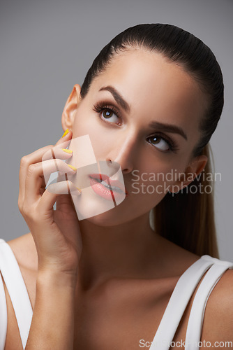 Image of Beauty salon, manicure and face of studio woman thinking of facial cosmetics, skincare or nail paint treatment. Nailpolish, clean hands and cosmetology model planning makeup idea on grey background