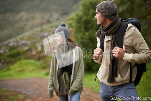 Image of Couple, happy and hiking in mountain or forest with travel, adventure or nature for wellness or fitness. Man, woman and trekking outdoor in woods for cardio, exercise or workout with view or backpack