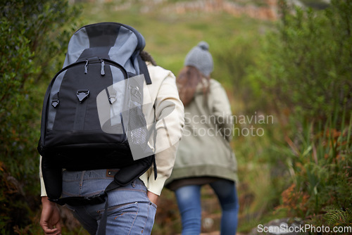 Image of Couple of friends, hiking in nature for travel, outdoor adventure or journey in forest or eco friendly woods. Back of people walking together or trekking in backpack on mountains path to explore