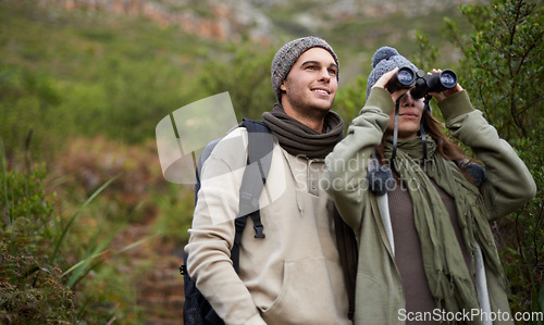 Image of Couple, travel in nature and binoculars for hiking, adventure and journey or explore together in eco friendly mountains. Happy man and woman trekking with outdoor search, vision or birdwatching lens