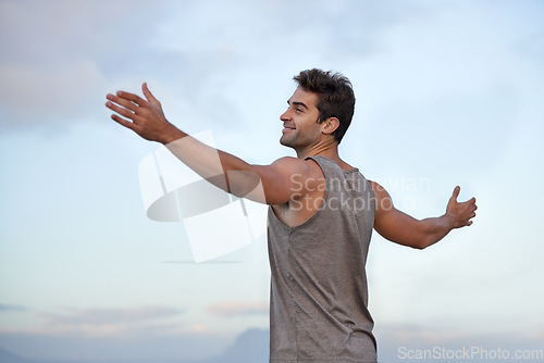 Image of Sky, happy and excited with man, vacation and journey with wellness and freedom with adventure. Person, outdoor and guy with arms raised, peace and happiness with holiday and adventure with smile