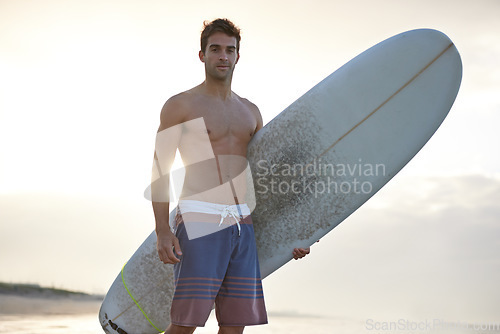 Image of Surfing, fitness and portrait of man at a beach with surfboard for fun, travel and sports outdoor. Ocean, training and male surfer at the sea for swimming, fun and adventure, workout and holiday