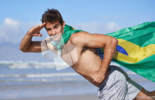 Image of Man, portrait and Brazilian flag on beach for patriotic pride or outdoor support for Country, nationality or nature. Male person, face and hand salute at ocean for holiday, vacation or citizenship