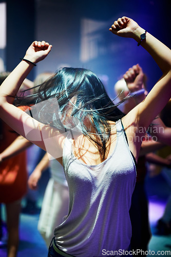 Image of Woman, dancing and music at rave, happy and party in nightclub, festival and dj event. Disco, rock and freedom with excited girl in crowd of fans for celebration, energy and techno performance