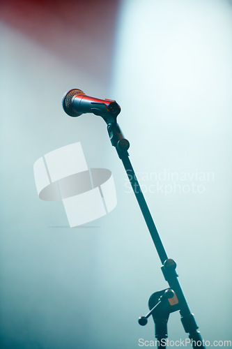 Image of Microphone stand, empty room and stage for karaoke in spotlight for audio performance with singing. Concert, technology and voice sound with electronics equipment and broadcast for jazz entertainment