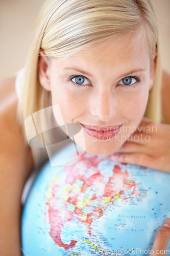 Image of Woman, travel and globe with portrait and happy from earth day, holiday or international vacation. Smile, world and map for learning and geography with a female person and choice with the planet