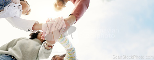 Image of Family, hands together and team in solidarity below for collaboration or celebration under sky. Low angle of mother, father and kids piling for teamwork motivation, support or coordination together
