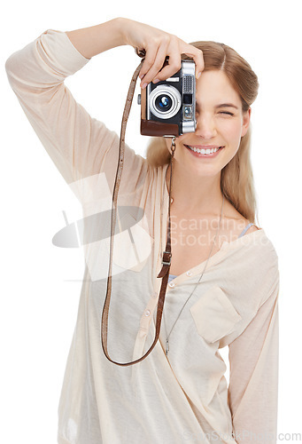 Image of Young photographer, camera and taking pictures in studio with happiness, talent and creative artist career. Woman, smile and photoshoot for professional production and focus lens by white background