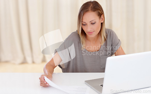 Image of Happy woman, laptop and documents for finance, budget planning or insurance on table at home. Female person smile with paperwork or invoice for bills, expenses or financial investment on computer