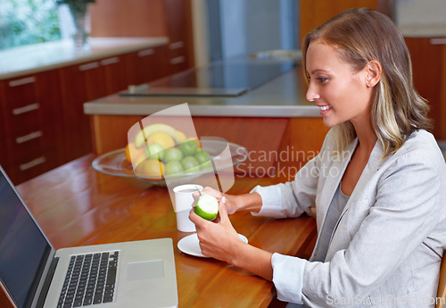 Image of Laptop, apple and business woman in home for morning routine for wellness, nutrition and healthy breakfast. Remote work, freelancer and person with fruit on computer for internet, website or research