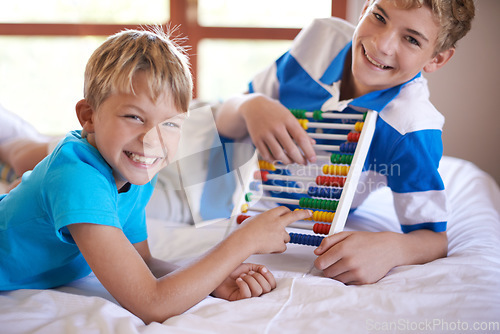Image of Children, home and portrait with abacus for learning, happy and bonding together by education toy for math. Brother, smile on face and counting game on bed for sibling love, and development in house