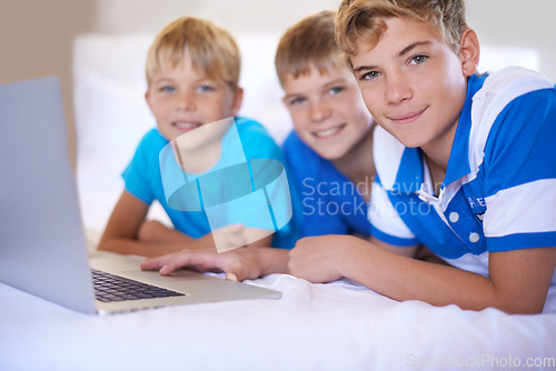 Image of Children, home and portrait on laptop in bedroom, smile and excited for online games in house. Young kids, happy face and streaming cartoons on bed for bonding together, siblings and relax on weekend