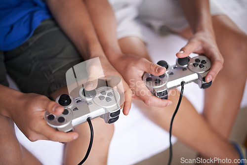 Image of Children, hands and video game controller in a house for gaming, subscription or entertainment closeup from above. Gamepad, zoom and gamer boy kids at home with esports, competition or challenge