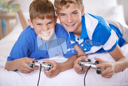 Image of Children, excited and portrait of video game in home, love and happy for online gaming in bedroom. Young brothers, smile and face for streaming sports on bed, bonding and relax together on weekend