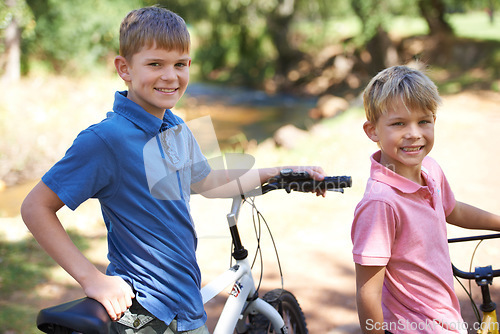 Image of Nature, bicycles and portrait of boy children riding in outdoor field, park or forest for exercise. Happy, cycling and confident young kids on bikes for cardio, hobby or training in a garden.