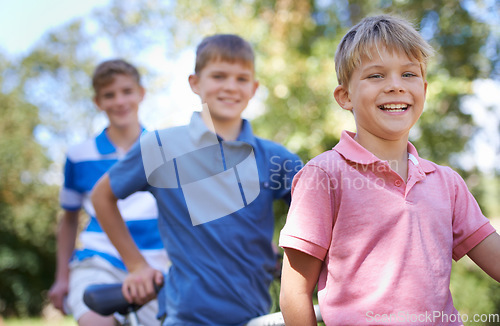 Image of Nature, smile and kids with bicycle in park learning to ride for exercise in an outdoor forest. Happy, bonding and portrait of young boy children to cycle on bike for hobby in field, woods or garden.