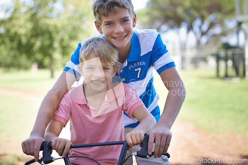 Image of Nature, smile and portrait of children on bicycle riding in outdoor field, park or forest for exercise. Happy, cycling and confident young boy kids on bike for cardio, hobby or training in a garden.