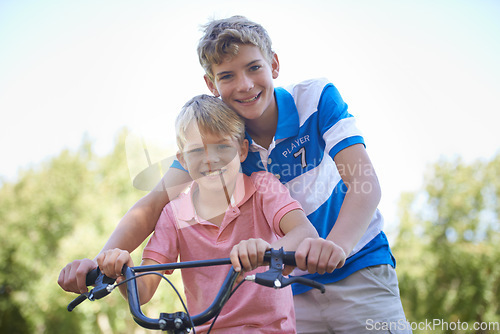 Image of Nature, happy and portrait of kids on bicycle riding in outdoor field, park or forest for exercise. Smile, cycling and confident young boy children on bike for cardio, hobby or training in a garden.