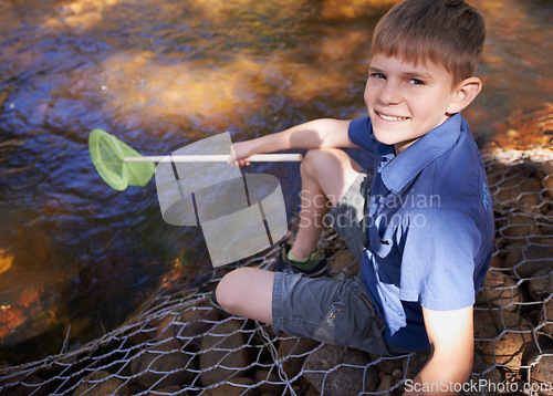 Image of Child, portrait and fishing net at river in nature for outdoor adventure or youth development, summer or countryside. Kid, boy and equipment for catch hobby in lake for learning, practice or skill