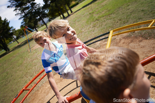 Image of Children, playground and carousel or park fun together as friends for speed, excitement or fast. Kids, boys and brothers on field for playing game in sunshine for bonding connection, outdoor or joy