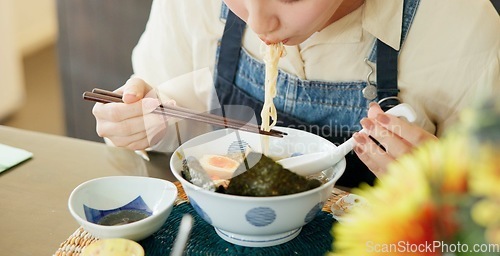 Image of Hungry woman, eating ramen and restaurant with chopsticks, noodles and lunch for nutrition. Girl, person and meal for health, wellness and diet for wellness at cafeteria, diner and brunch in Tokyo