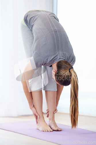 Image of Woman, stretching legs and yoga for health, wellness and warm up in home with holistic fitness or workout. Person, yogi or lady for flexibility, muscle and body for balance in practice or pilates