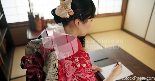 Image of Traditional, writing and Japanese woman in home with paper, documents and script at desk. Creative, Asian culture and person with paintbrush, ink and tools for calligraphy, font and text in house