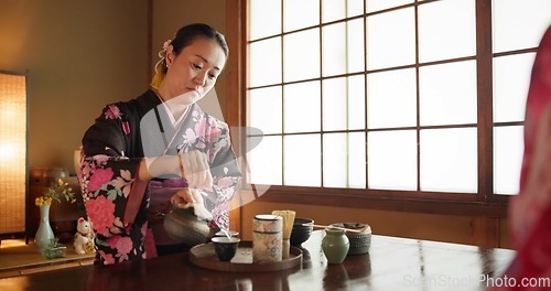 Image of Traditional, culture and Japanese woman with tea in home with herbs, leaves and flavor in teapot. Kimono, indigenous and person with matcha beverage for ceremony, ritual and wellness for drinking