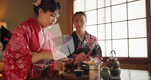 Image of Japanese, people and kimono for tea ceremony in Chashitsu room with peace or custom tradition. Women, temae and vintage style dress or talking with culture, fashion and friends with antique crockery