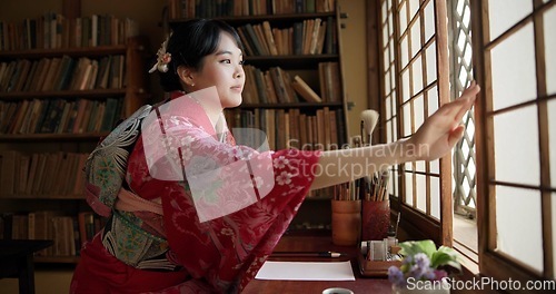 Image of Open window, Japanese and woman with architecture, apartment and morning with culture. Library, calm and zen with sliding door, female person and traditional dress with accommodation in Tokyo