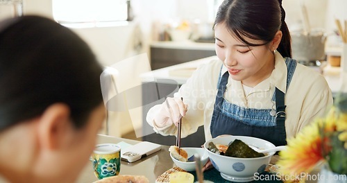 Image of Japanese woman, eating and lunch in restaurant, chopsticks and hungry with plate for nutrition. Girl, people and food for health, wellness and diet with choice at cafeteria, diner and brunch in Tokyo