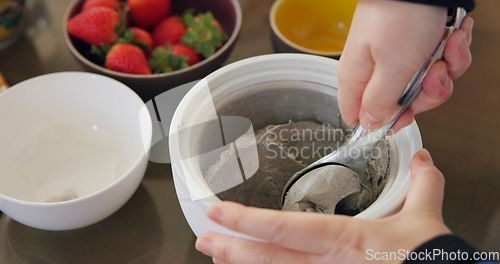 Image of Hands, ice cream and fruit in kitchen for cooking or preparing dessert on wooden table from above. Food, strawberry or ingredients for recipe with professional culinary chef in restaurant or class