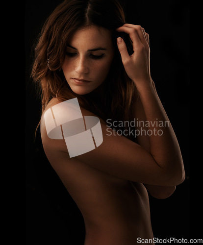 Image of Woman, body and skincare in studio for cosmetics, dermatology and shadow for art deco and aesthetic. Beauty model or serious person thinking of self care and glow isolated on dark or black background