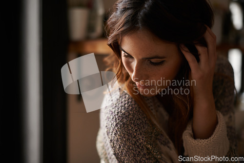 Image of Lonely, depression and young woman at a home with upset, grief and mad facial expression for problem. Mental health, emotion and sad female person looking down with unhappy face for loss at house.