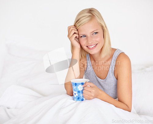 Image of Happy woman, relax and thinking in bed with coffee and wake up with ideas for morning or future. Healthy, mindset and girl with tea in bedroom on holiday, vacation or wellness from rest in apartment