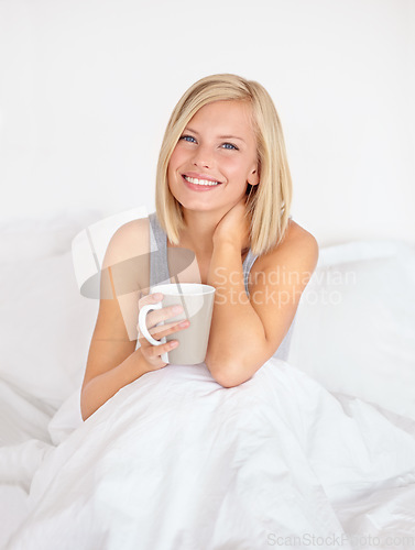 Image of Woman, portrait and coffee in bedroom for morning relax or home beverage for comfort, peace or happy. Female person, face and smile or drinking mug on duvet or warm caffeine for vacation, rest or tea