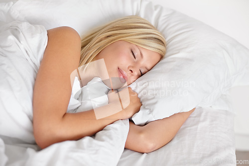 Image of Woman, bed and sleeping with face, relax and dreaming in bedroom, resting and Apartment in morning. Tired, blanket and eyes closed on pillow, young female asleep in house on weekend with fatigue