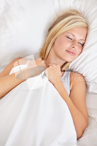 Image of Sleeping, peace and tired woman in a bed resting, dreaming and comfortable at home from above. Eyes closed, face and person asleep in a bedroom with vacation, holiday or snooze in day off in a house