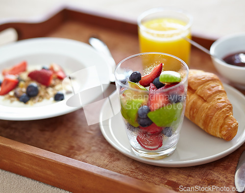 Image of Wellness, food and closeup of breakfast tray with muesli for balance, benefits or gut health. Fruit, zoom and croissant with vitamins for diet, nutrition or healthy eating, brunch or superfoods salad