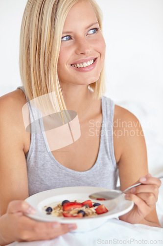 Image of Woman, thinking and breakfast in bedroom, hotel and wake up for morning hospitality or accommodation. Relax, cereal and holiday with young person in bed with fruit, weekend and comfortable with food