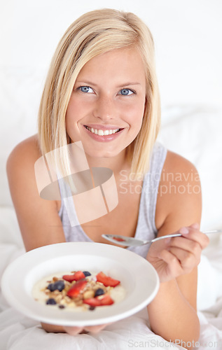 Image of Happy woman, portrait and breakfast in bed with muesli, meal or berries for balance, wellness or gut health at home. Fruit, eating or lady person face in bedroom for diet, nutrition or superfoods