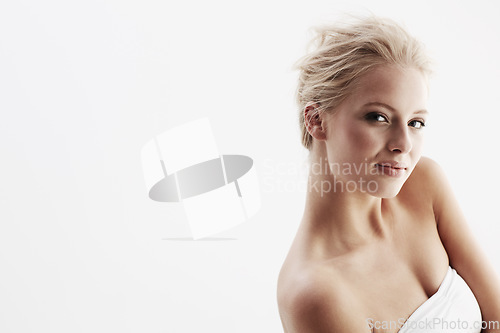 Image of Young woman, portrait and beauty in studio, confident and spa skincare treatment by white background. Blonde model, face and pride for cosmetology, feminine and glow skin with dermatology or make up