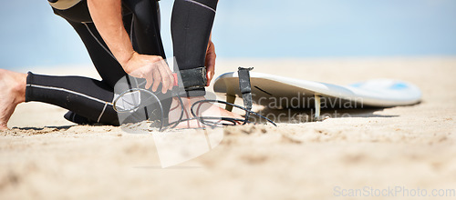 Image of Legs, strap for safety and surfer on beach for sports, fitness and training on travel vacation in summer. Hands, ankle and surfboard with person on sand by ocean or sea for surfing hobby or holiday