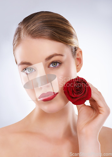 Image of Portrait, rose and woman with skincare, dermatology and beauty on a white studio background. Face, person and model with flowers and grooming with natural cosmetics and treatment with shine and glow