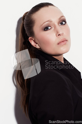 Image of Portrait, fashion and beauty of serious woman in studio isolated on a white background. Face, makeup and young model or person in cosmetics, stylish blazer and trendy clothes on a backdrop in Spain