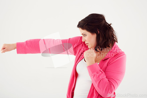 Image of Woman, profile and boxing with fist in fitness, exercise or workout on a white studio background. Active female person, brunette or fighter in self defense practice, training or punches on mockup